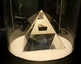 Moon rock in plastic pyramid.